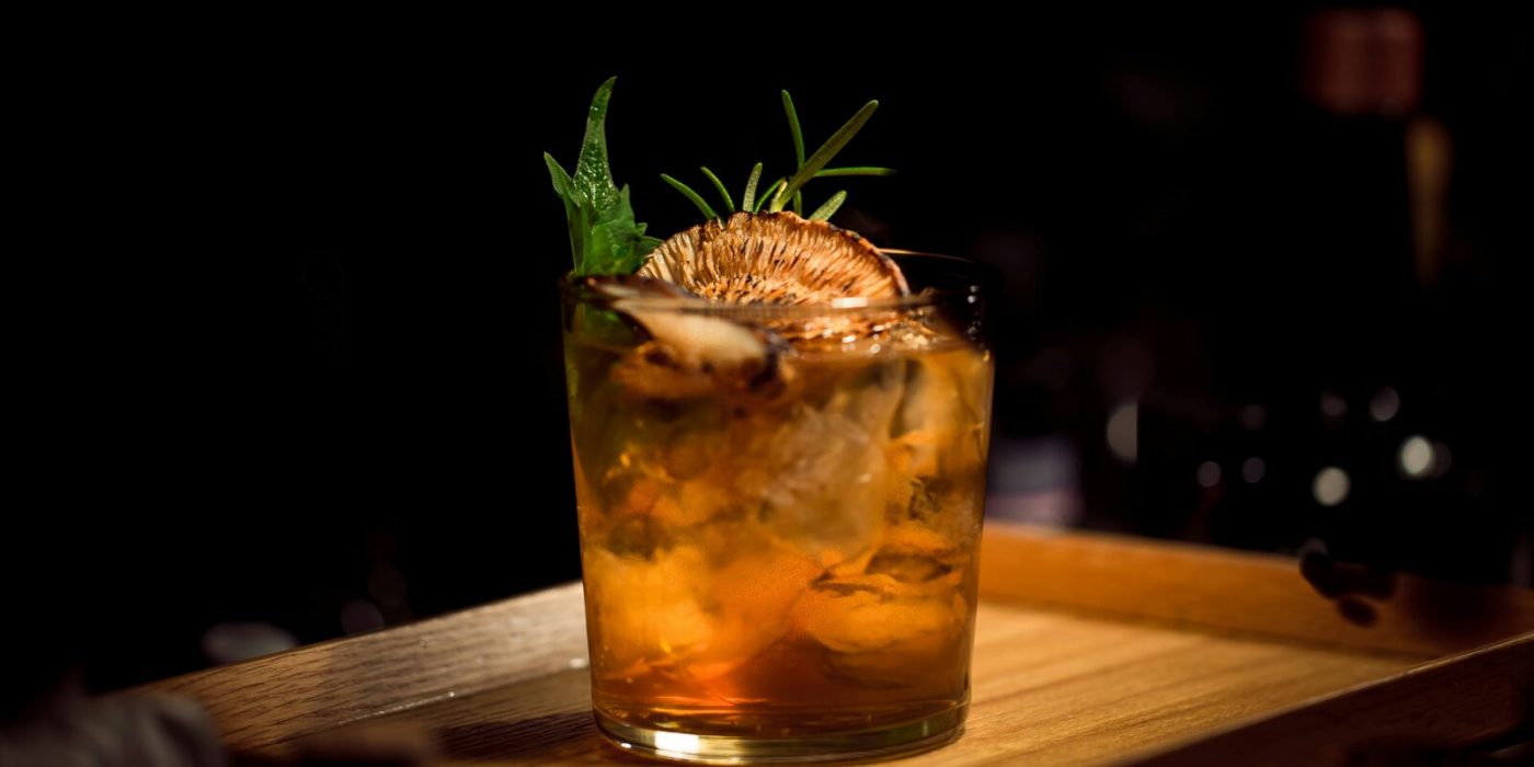 Novo cocktail decorado com ervas e citrinos fumados